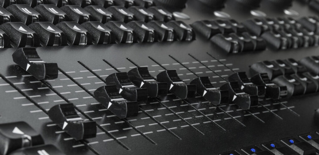 Modern audio desk with faders and buttons